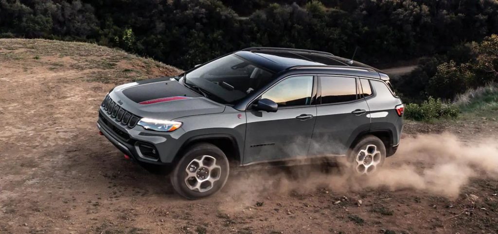 Gray 2022 Jeep Compass driving on a dirt hill.