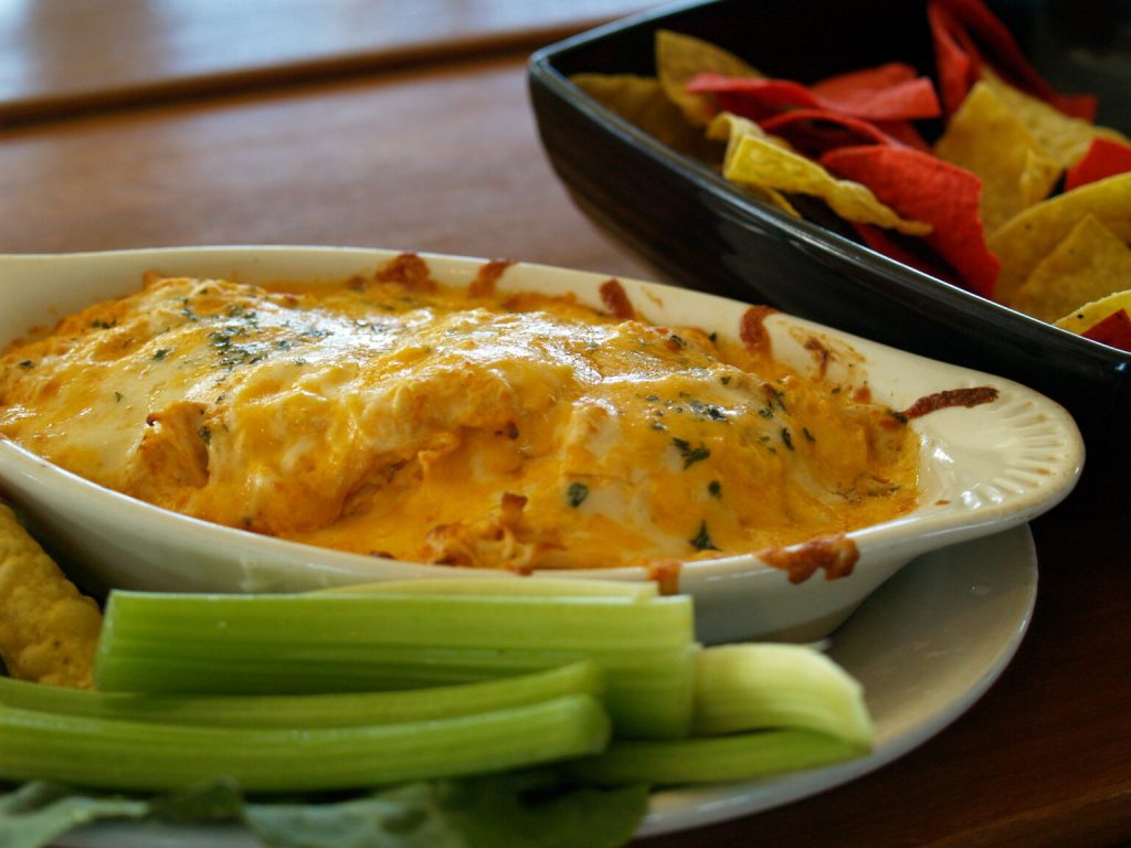 Image of buffalo chicken dip served at Benny's Pizza in Ohio with a side of celery.