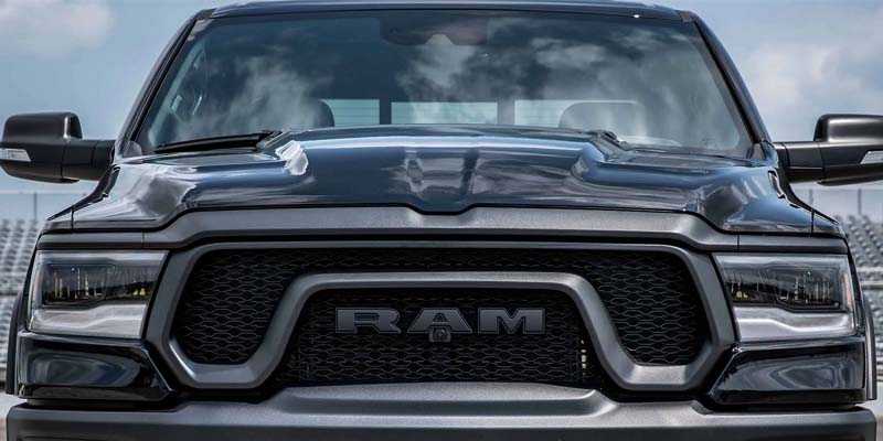 The front grill of a black 2023 Ram 1500 truck.
