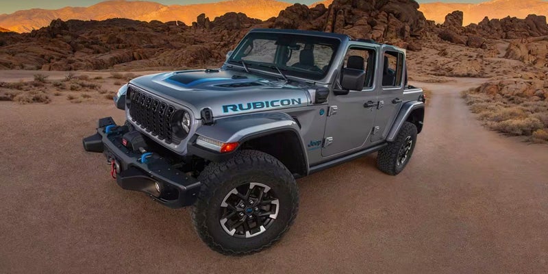 A silver 2024 Jeep Wrangler in the desert.